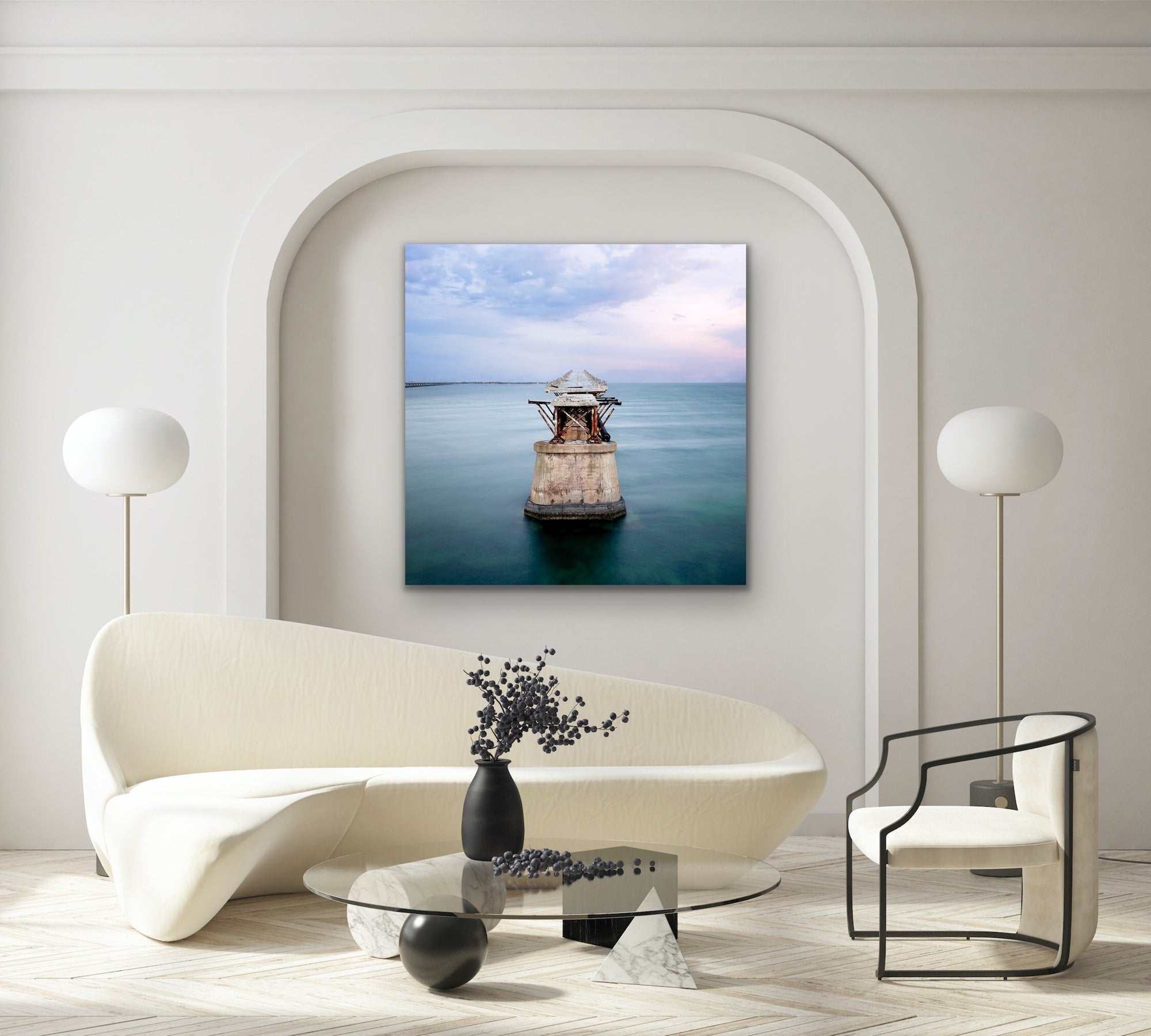 Image of abandoned pier in middle of the ocean framed over a sofa.