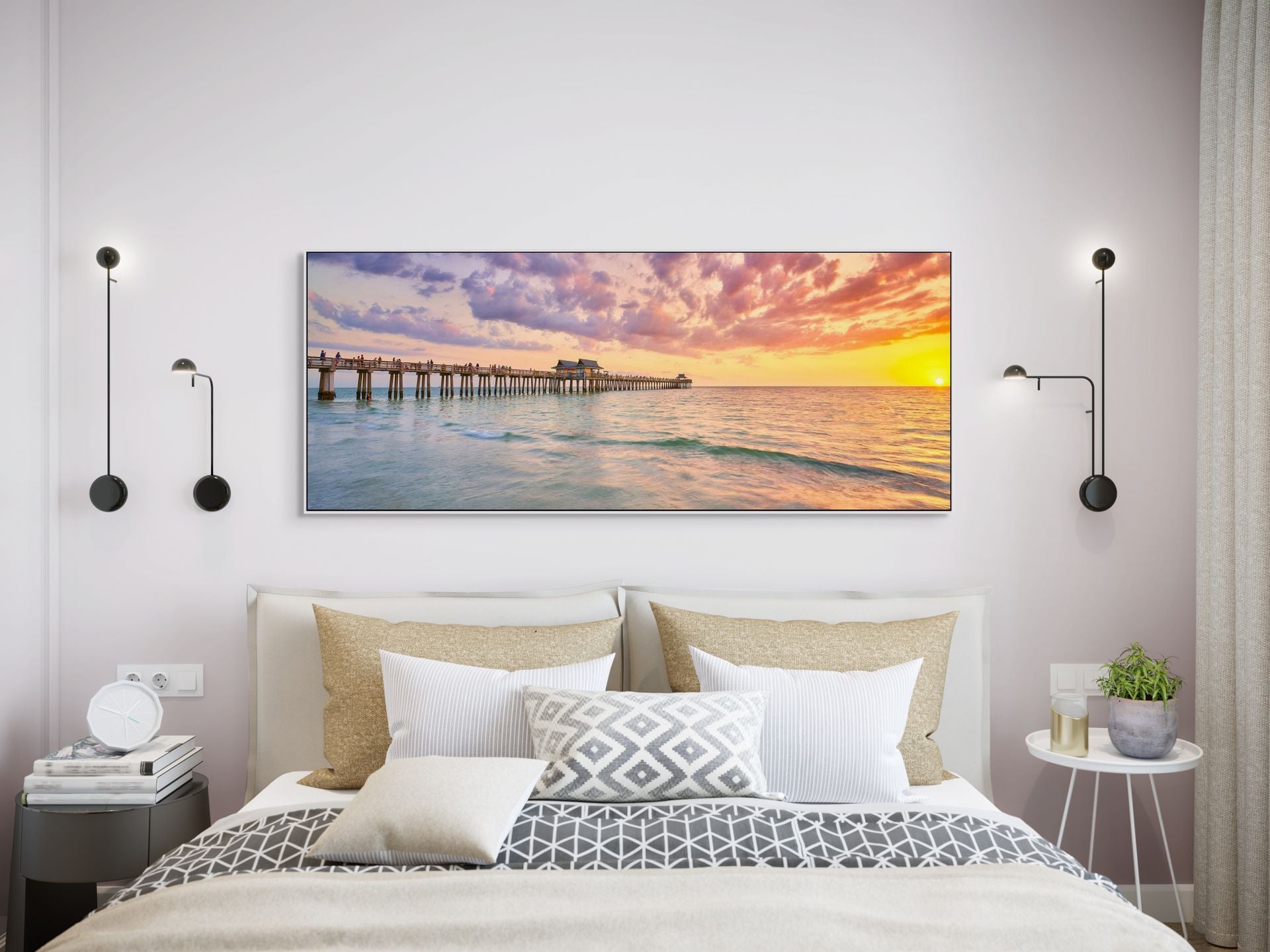 Image of a pier extending into the ocean at sunset hanging over a bed.