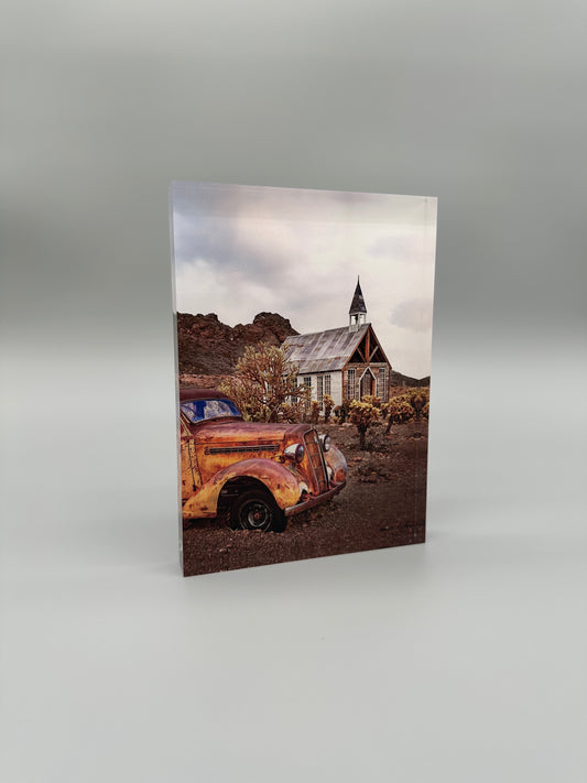 Rustic scene with an old car and a small church