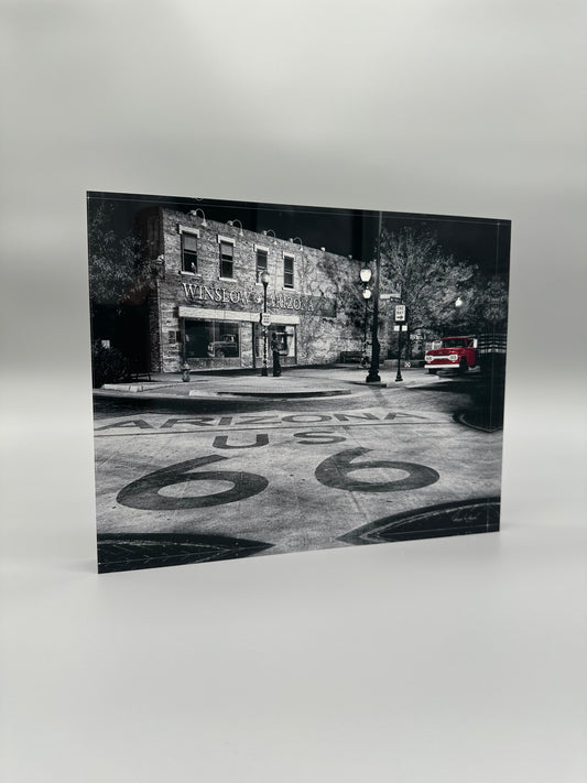 Black and white photo of a street scene with 'Arizona US 66' on the road.