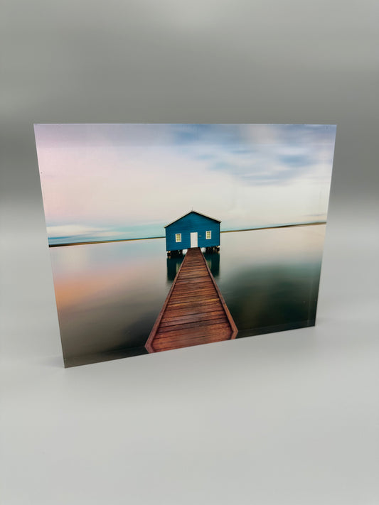 Acrylic resin block with a lake house on the water