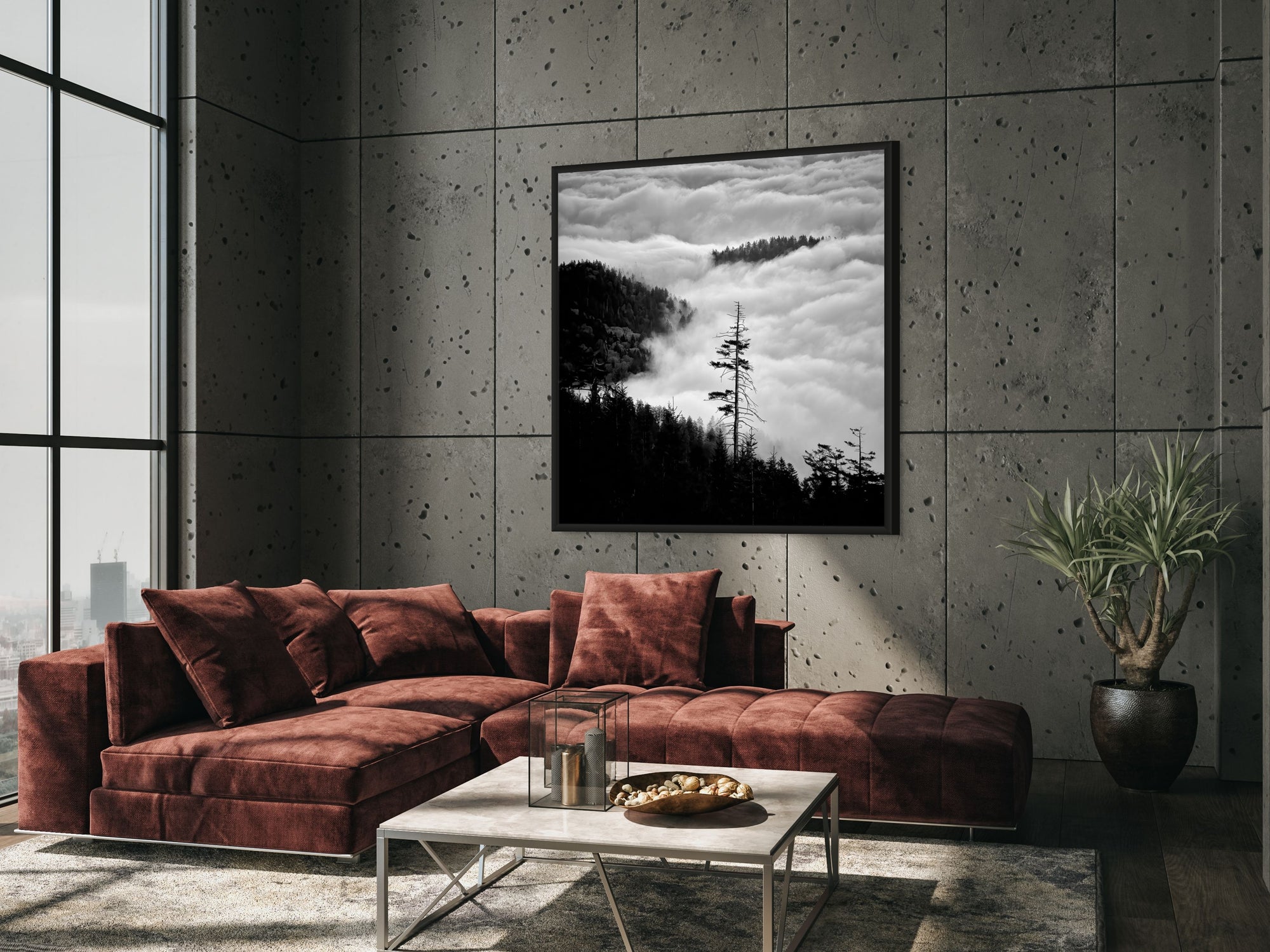 Image shot looking down mountain, clouds and trees in view, framed over sofa