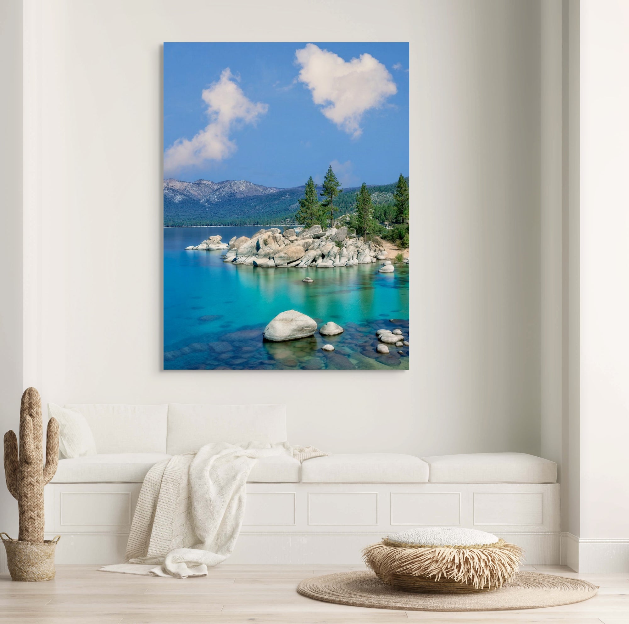 Scenic wall art of a lake with mountains and clouds in a modern living room.