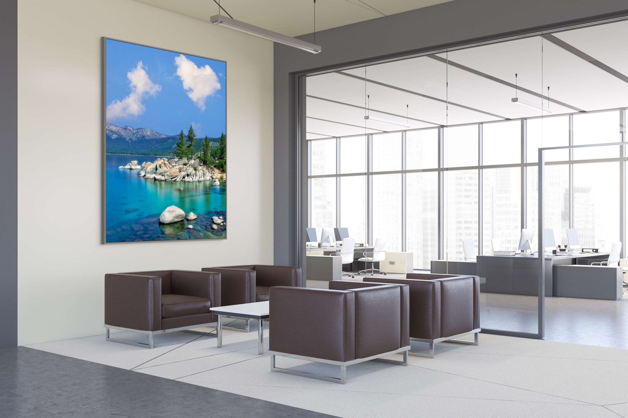 Modern office interior with a large wall-mounted screen displaying a scenic view.