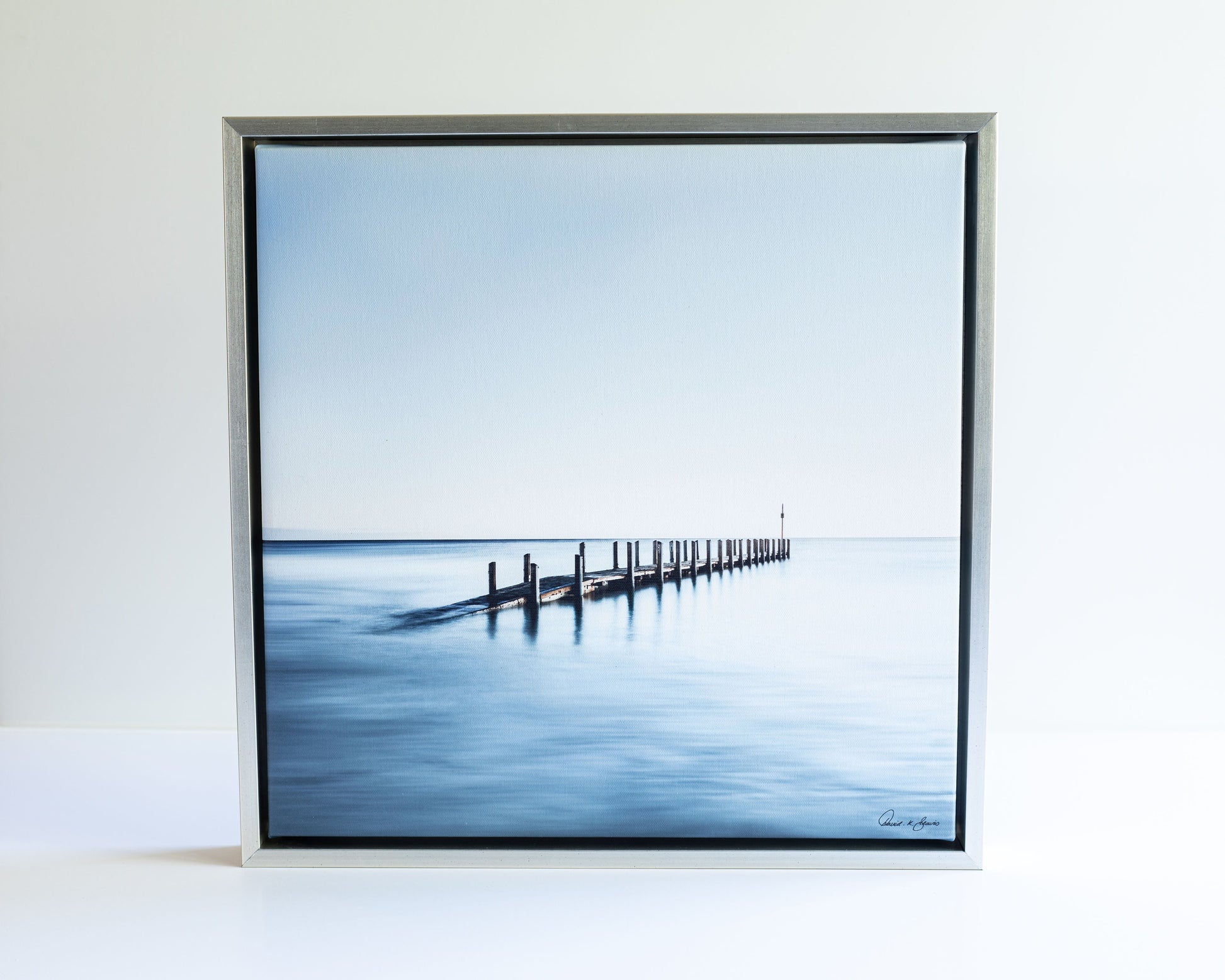 Grey and blue calm waters and wooden dock rising out of the ocean David K Beavis Artist Choice Print High Tide