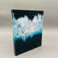 Blue and white abstract design on a dark background
