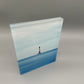 Acrylic block with a lighthouse design on water