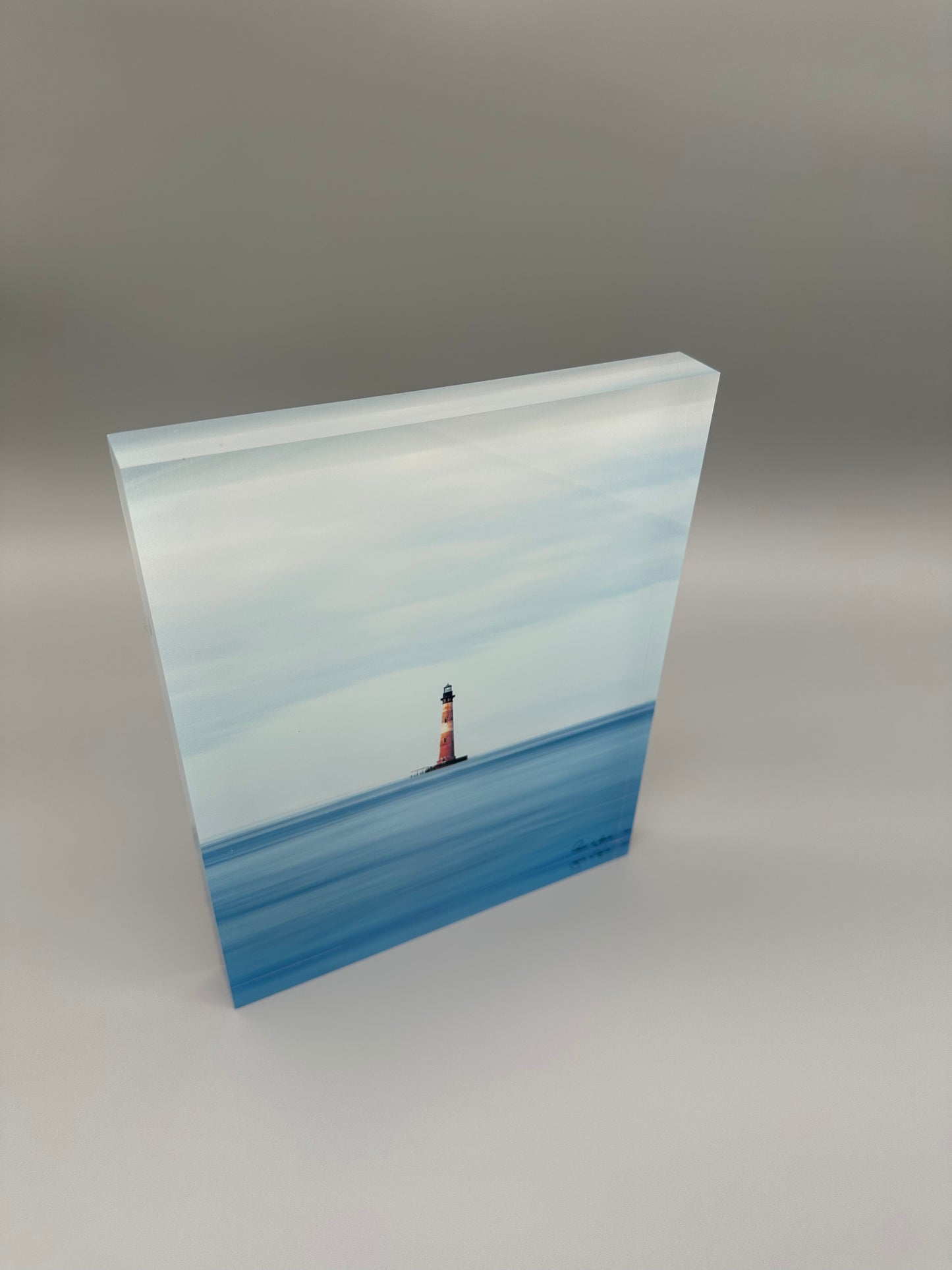 Acrylic block with a lighthouse design on water