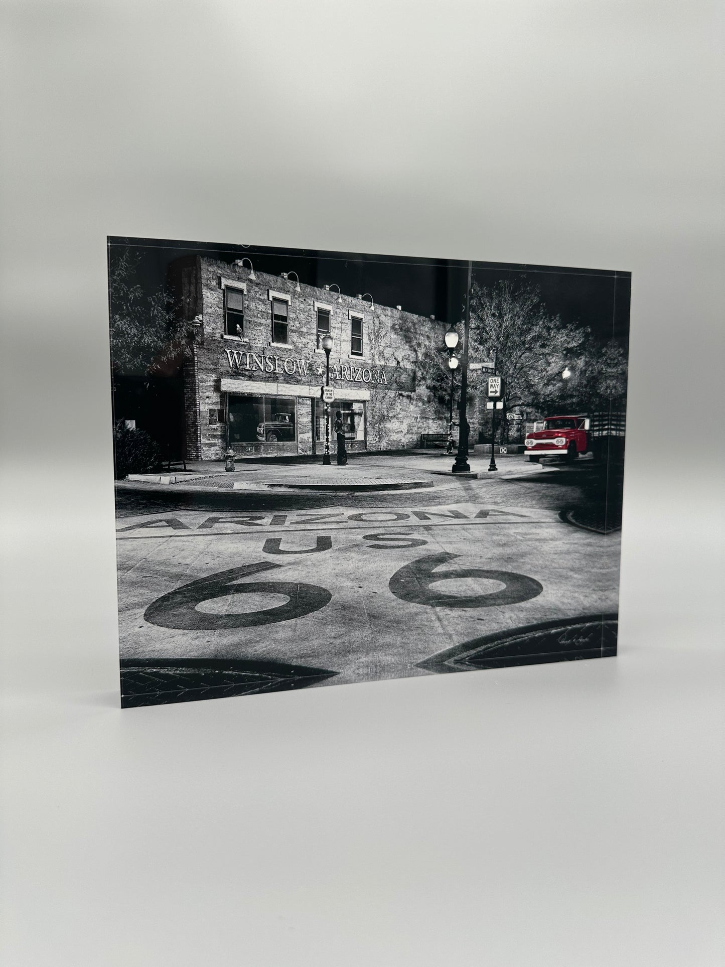 Black and white photo of a street scene with 'Arizona US 66' on the road.