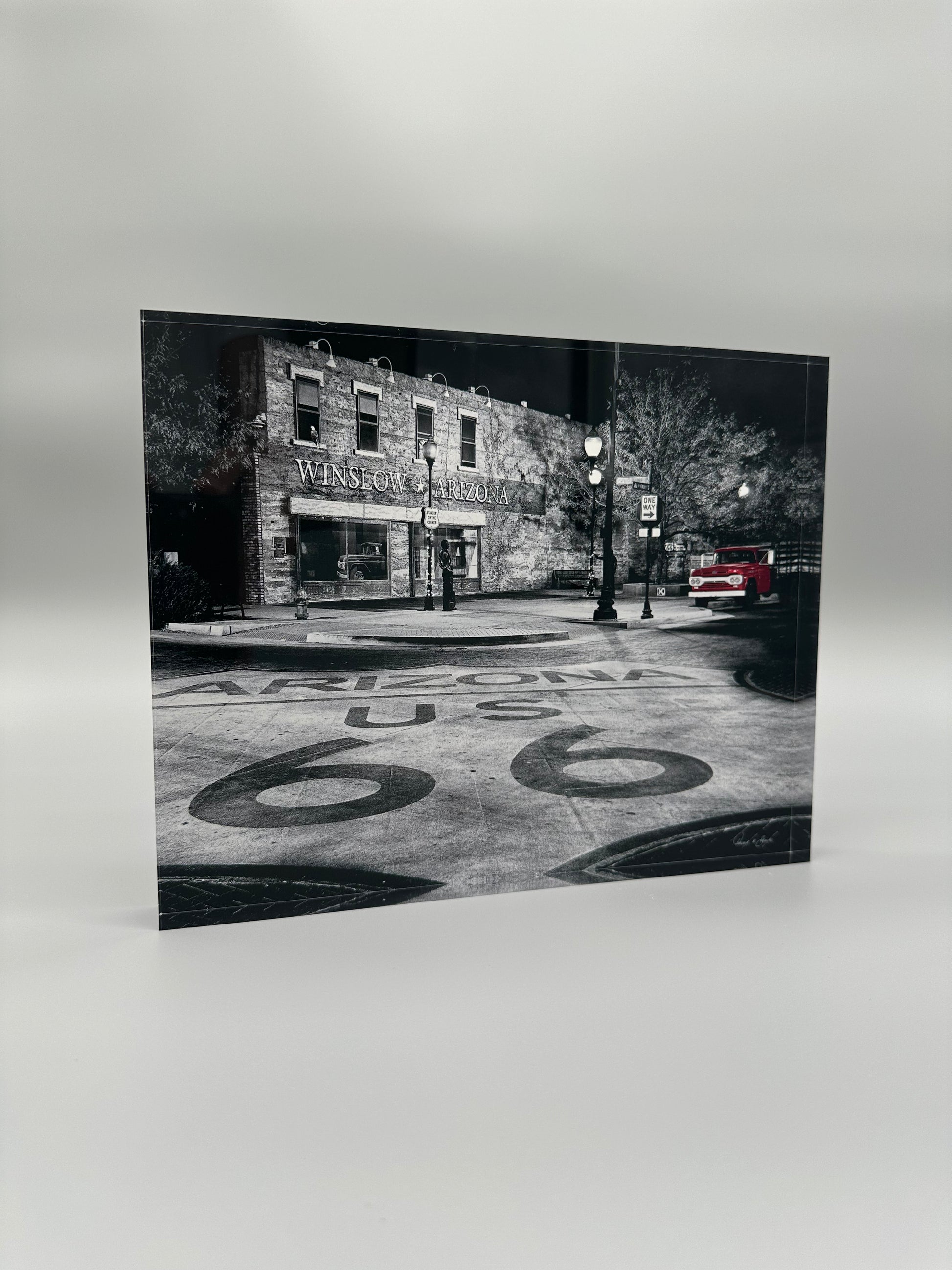 Black and white photo of a street scene with 'Arizona US 66' on the road.
