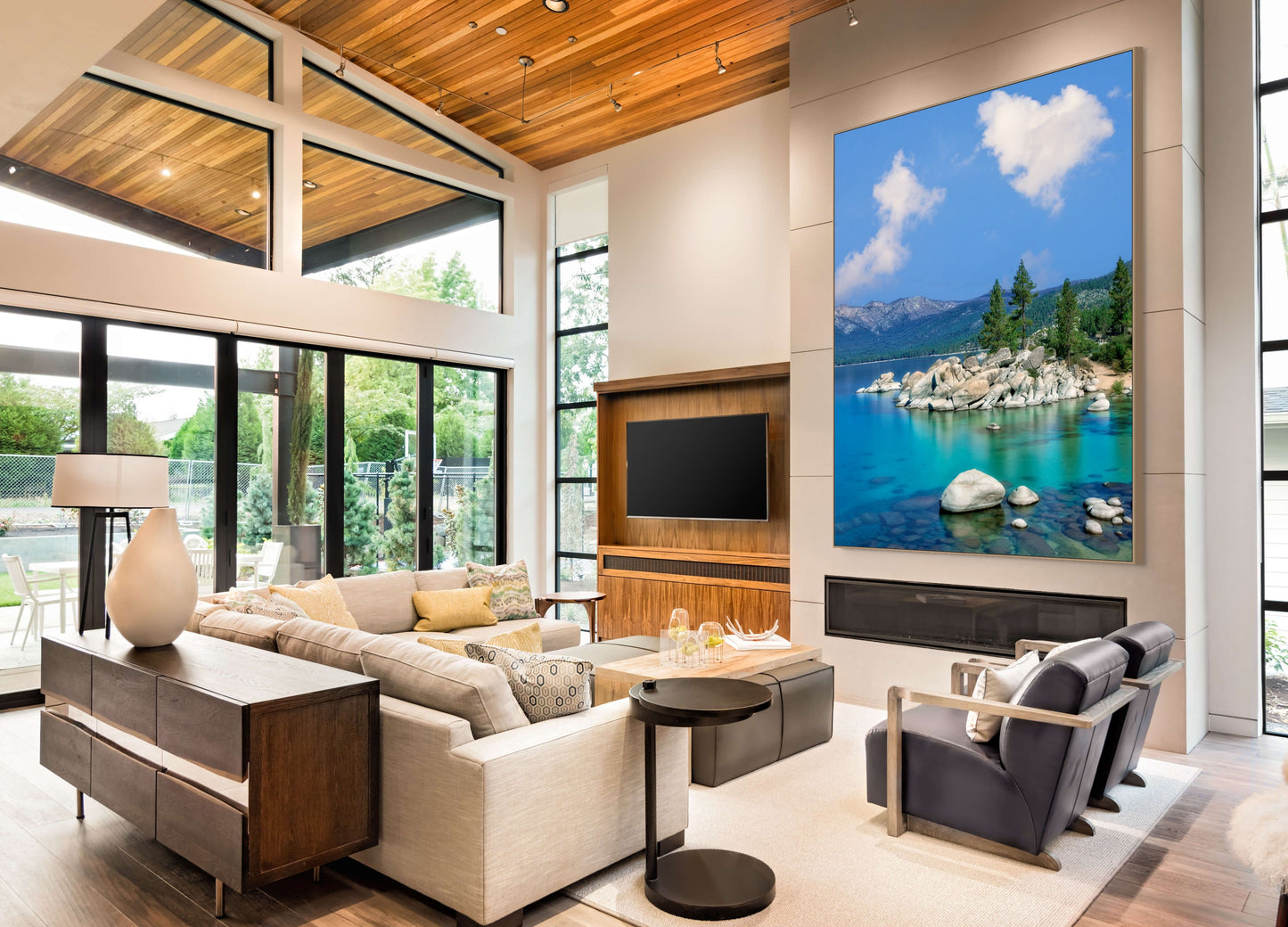 Modern living room with a large TV displaying a scenic landscape.